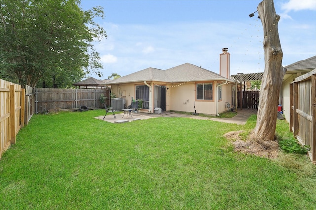 9228 Waving Fields Dr, Houston, TX 77064 - rear view of property with central AC unit, a chimney, and a patio