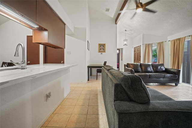 9228 Waving Fields Dr, Houston, TX 77064 - living room with light tile patterned floors, lofted ceiling, a ceiling fan, and a textured ceiling