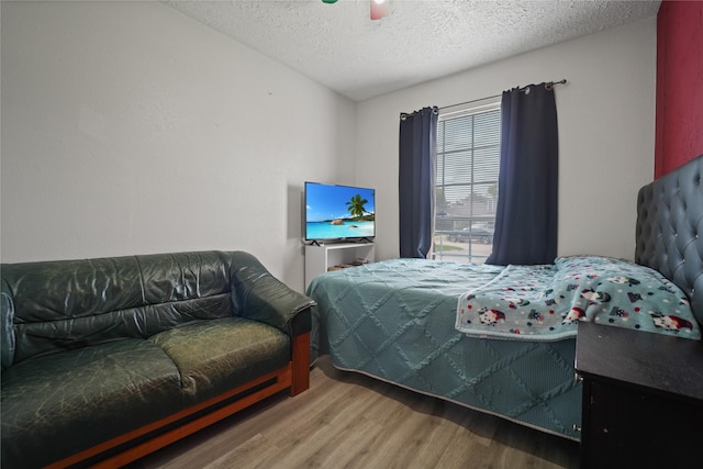9228 Waving Fields Dr, Houston, TX 77064 - bedroom with wood finished floors and a textured ceiling