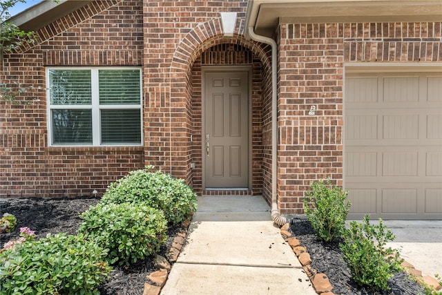 2206 Hidden Meadow Ln, Pearland, TX 77089 - view of exterior entry with brick siding and an attached garage