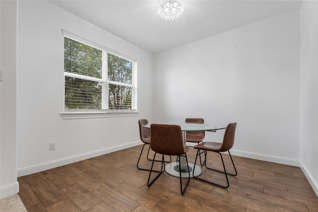 2206 Hidden Meadow Ln, Pearland, TX 77089 - dining space with baseboards, wood finished floors, and a chandelier