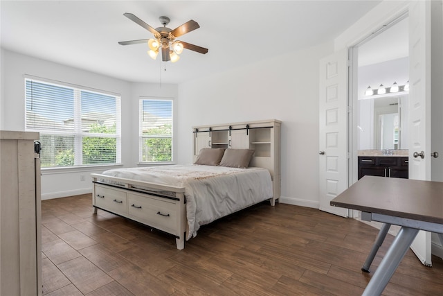 2206 Hidden Meadow Ln, Pearland, TX 77089 - bedroom with dark wood-type flooring, baseboards, a ceiling fan, and a sink