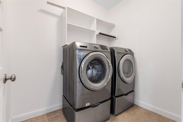2206 Hidden Meadow Ln, Pearland, TX 77089 - washroom featuring washing machine and dryer, baseboards, and light tile patterned floors