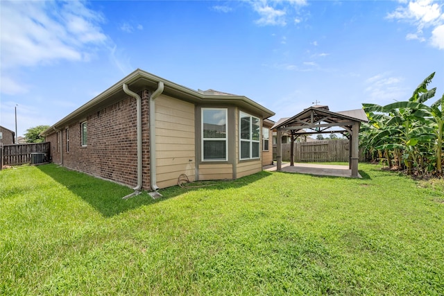 2206 Hidden Meadow Ln, Pearland, TX 77089 - back of property featuring a gazebo, a patio area, cooling unit, and brick siding