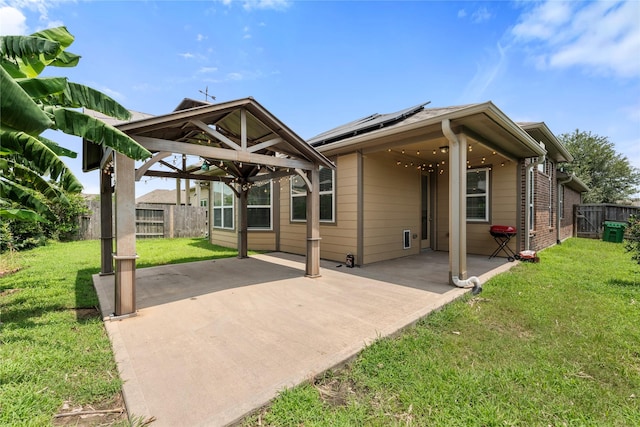 2206 Hidden Meadow Ln, Pearland, TX 77089 - rear view of property featuring a patio area and roof mounted solar panels