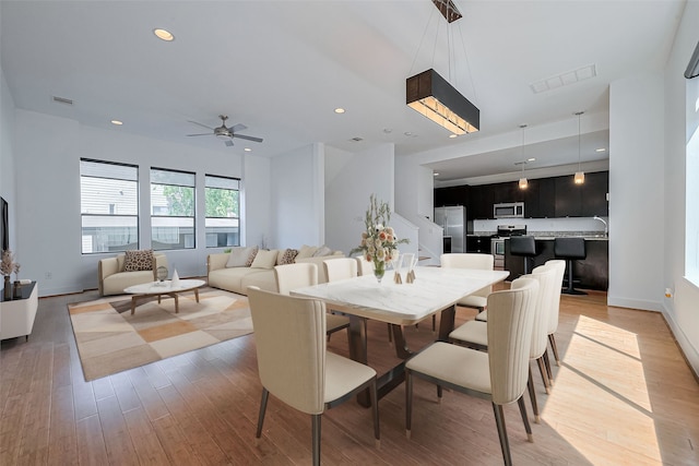 5012 Cornish St, Houston, TX 77007 - dining room with light wood-type flooring, a ceiling fan, baseboards, and recessed lighting