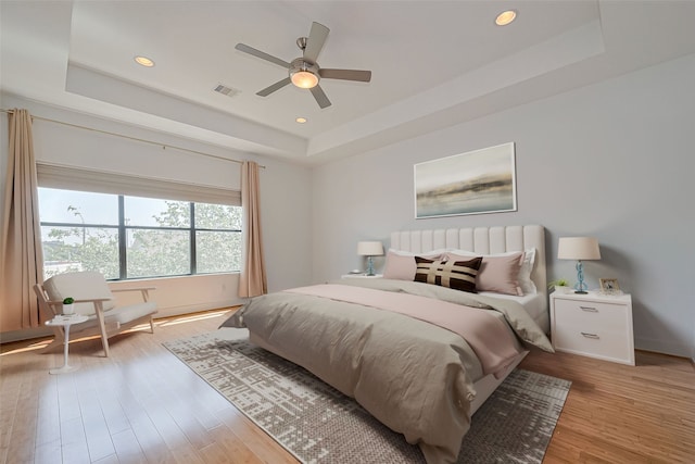 5012 Cornish St, Houston, TX 77007 - bedroom with a tray ceiling, wood finished floors, ceiling fan, recessed lighting, and baseboards
