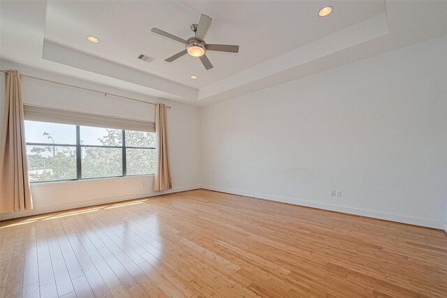 5012 Cornish St, Houston, TX 77007 - unfurnished room with a tray ceiling, light wood finished floors, a ceiling fan, and recessed lighting
