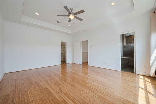 5012 Cornish St, Houston, TX 77007 - unfurnished bedroom featuring a tray ceiling, light wood finished floors, a spacious closet, baseboards, and recessed lighting