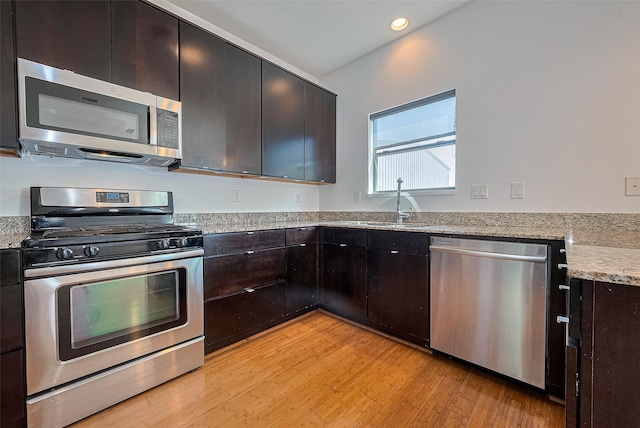 5012 Cornish St, Houston, TX 77007 - kitchen with appliances with stainless steel finishes, light wood-style flooring, a sink, light stone countertops, and recessed lighting