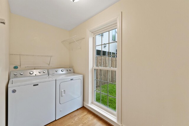2044 Branard St, Houston, TX 77098 - laundry area with independent washer and dryer and light wood-style floors