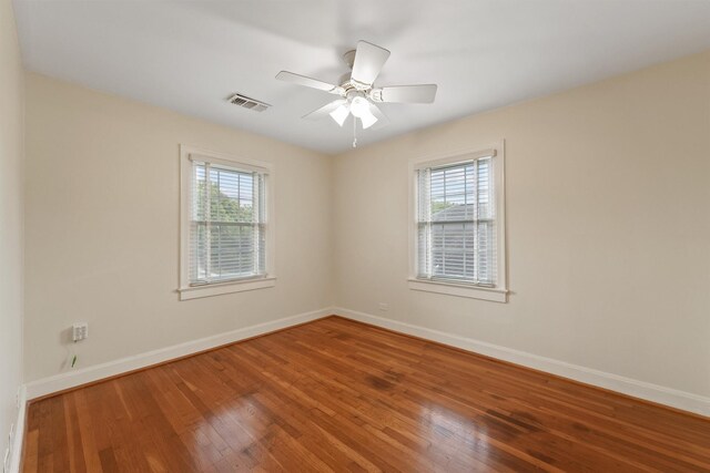2044 Branard St, Houston, TX 77098 - empty room featuring plenty of natural light, wood finished floors, baseboards, and ceiling fan