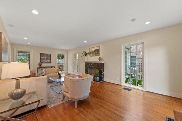 2044 Branard St, Houston, TX 77098 - living room with a fireplace with flush hearth, wood finished floors, baseboards, and recessed lighting