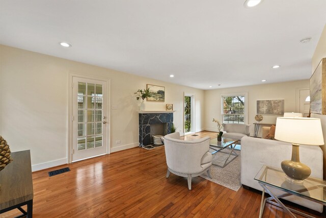 2044 Branard St, Houston, TX 77098 - living room with wood finished floors, a fireplace, recessed lighting, and baseboards