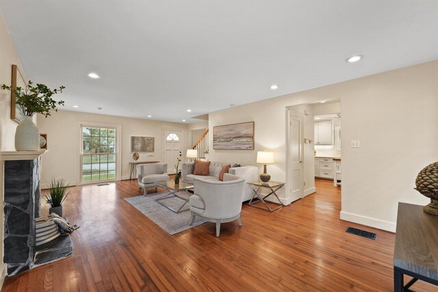 2044 Branard St, Houston, TX 77098 - living room featuring stairs, a fireplace, wood finished floors, recessed lighting, and baseboards