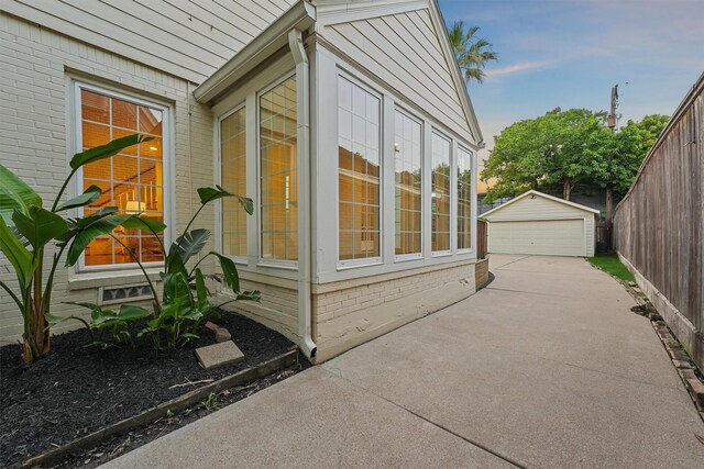 2044 Branard St, Houston, TX 77098 - view of home's exterior featuring a garage, an outdoor structure, and brick siding