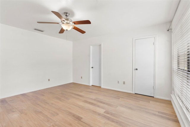 8903 Roos Rd, Houston, TX 77036 - unfurnished bedroom featuring multiple closets, light wood finished floors, ceiling fan, and baseboards