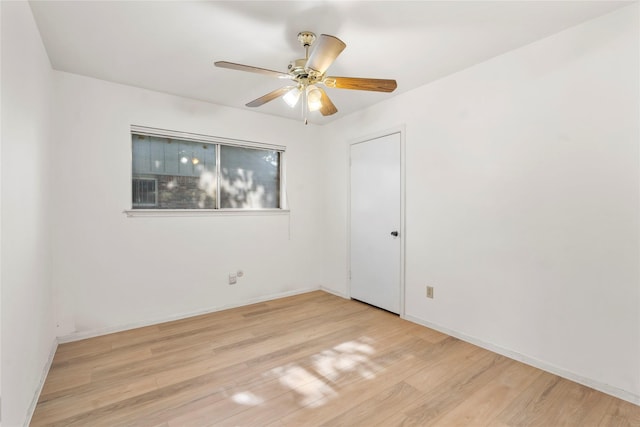 8903 Roos Rd, Houston, TX 77036 - empty room with a ceiling fan, light wood finished floors, and baseboards