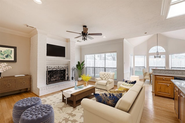 13223 Oregold Dr, Houston, TX 77041 - living area with light wood-type flooring, a fireplace, ceiling fan, crown molding, and vaulted ceiling
