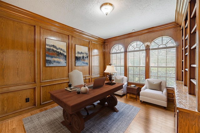 13223 Oregold Dr, Houston, TX 77041 - home office with a textured ceiling, light wood-type flooring, wooden walls, and ornamental molding