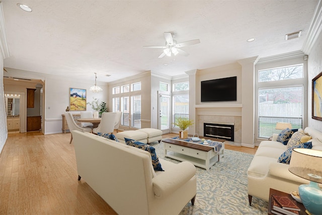 13223 Oregold Dr, Houston, TX 77041 - living room featuring crown molding, light wood-style flooring, a ceiling fan, a textured ceiling, and baseboards
