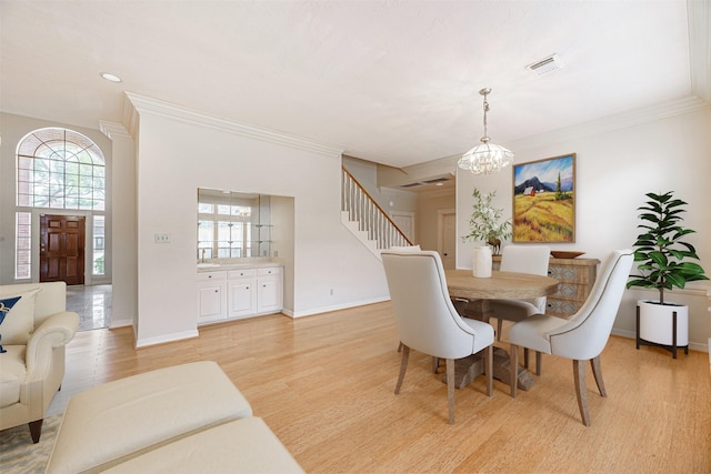 13223 Oregold Dr, Houston, TX 77041 - dining room with a chandelier, light wood-type flooring, plenty of natural light, stairway, and crown molding