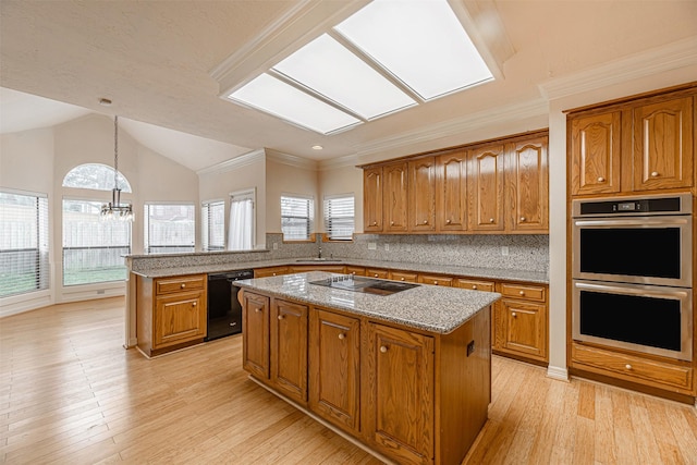 13223 Oregold Dr, Houston, TX 77041 - kitchen featuring black appliances, brown cabinets, a sink, a kitchen island, and a chandelier