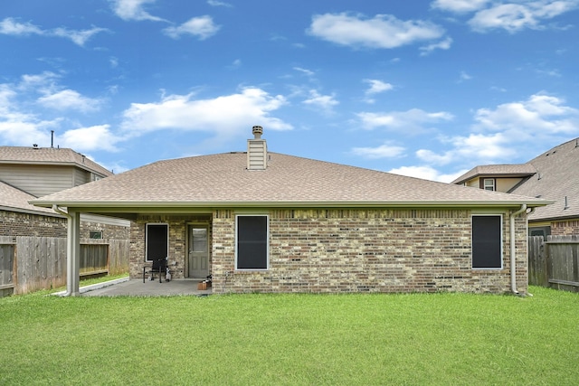 2507 Ocean Pass Ln, Richmond, TX 77469 - back of property with brick siding, a patio, a shingled roof, and a chimney