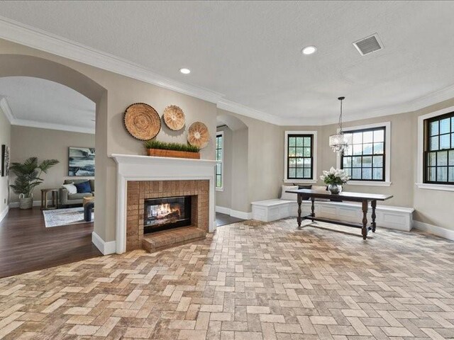 9622 Hanging Moss Trl, Houston, TX 77064 - living room with arched walkways, a brick fireplace, baseboards, crown molding, and recessed lighting