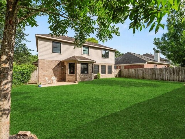 9622 Hanging Moss Trl, Houston, TX 77064 - back of house featuring brick siding and a patio