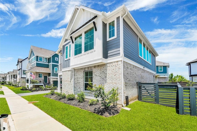 15147 Colorado Bend Park Dr, Cypress, TX 77433 - view of property exterior featuring board and batten siding, a residential view, and brick siding