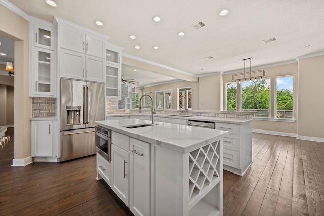 806 Quintana Roo Pl, Seabrook, TX 77586 - kitchen featuring stainless steel appliances, a sink, a center island with sink, white cabinetry, and tasteful backsplash