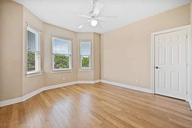 806 Quintana Roo Pl, Seabrook, TX 77586 - empty room featuring light wood finished floors, ceiling fan, and baseboards