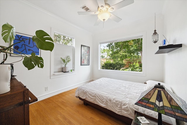 404 E 28th St, Houston, TX 77008 - bedroom featuring wood finished floors, crown molding, baseboards, and a ceiling fan