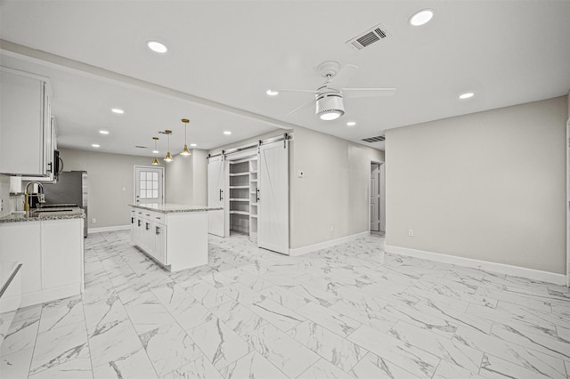 702 Norell St, Channelview, TX 77530 - spare room with a barn door, light marble finish flooring, a ceiling fan, baseboards, and recessed lighting