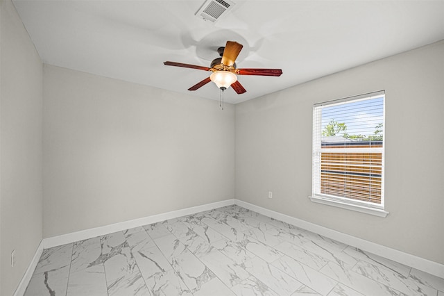 702 Norell St, Channelview, TX 77530 - spare room featuring light marble finish floors, ceiling fan, and baseboards