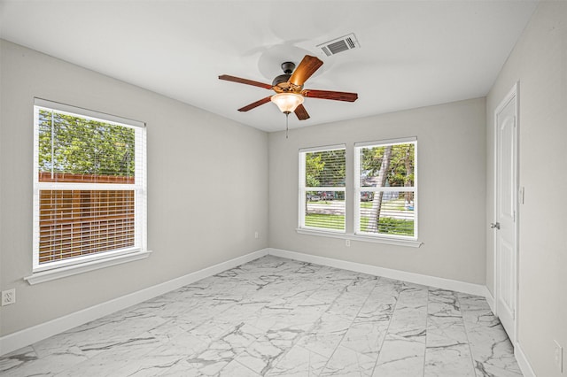 702 Norell St, Channelview, TX 77530 - empty room with light marble finish floors, ceiling fan, and baseboards