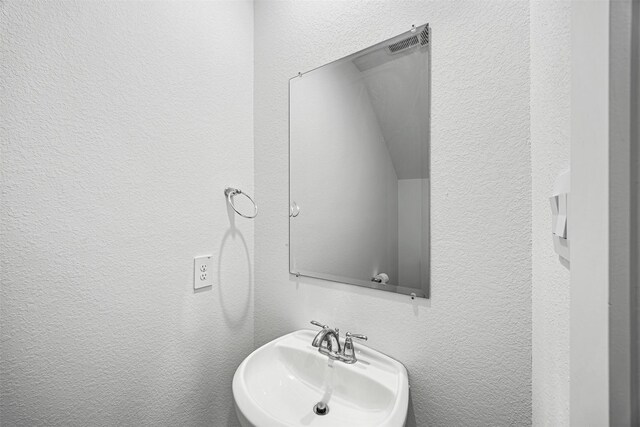 12305 Brandenburg Gate Dr, Houston, TX 77047 - bathroom with a sink and a textured wall