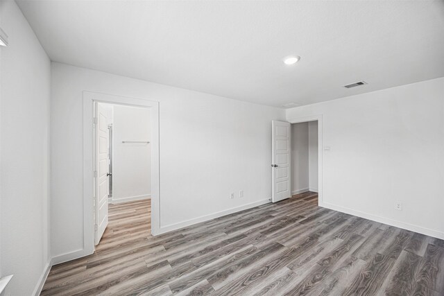 12305 Brandenburg Gate Dr, Houston, TX 77047 - empty room with wood finished floors, baseboards, and recessed lighting