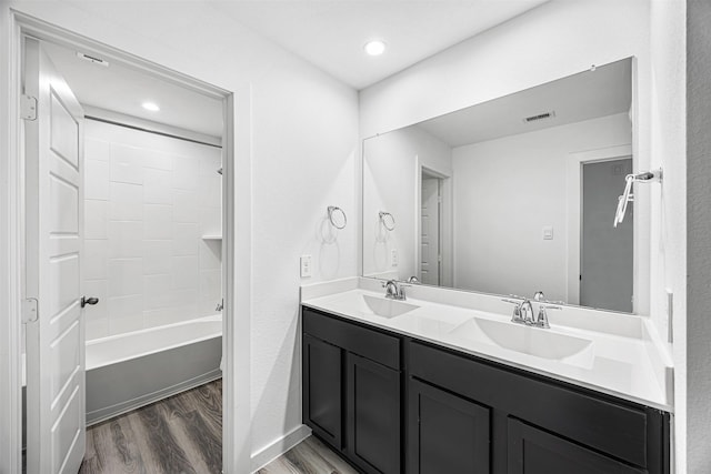 12305 Brandenburg Gate Dr, Houston, TX 77047 - full bathroom with wood finished floors, double vanity, shower / tub combination, recessed lighting, and baseboards