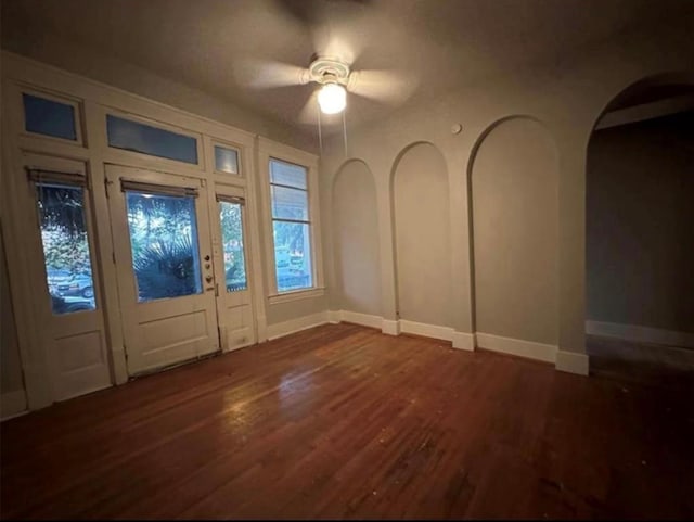 2518 Grant St, Houston, TX 77006 - entrance foyer featuring arched walkways, ceiling fan, dark wood-style flooring, and baseboards