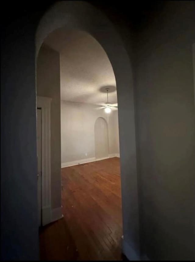 2518 Grant St, Houston, TX 77006 - hall with arched walkways, wood finished floors, and baseboards