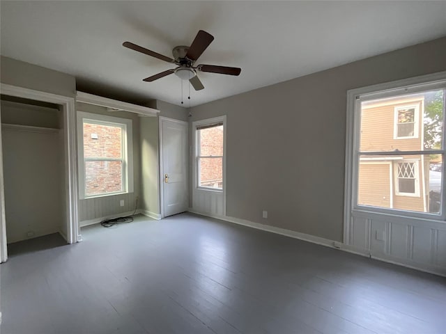 2518 Grant St, Houston, TX 77006 - unfurnished bedroom with wood finished floors, two closets, baseboards, and a ceiling fan