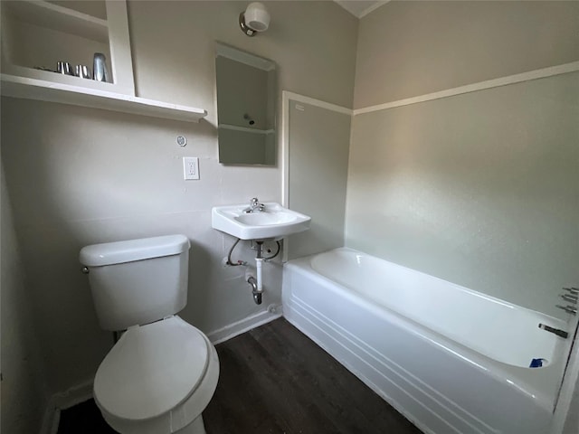 2518 Grant St, Houston, TX 77006 - bathroom featuring toilet, wood finished floors, a tub, and a sink