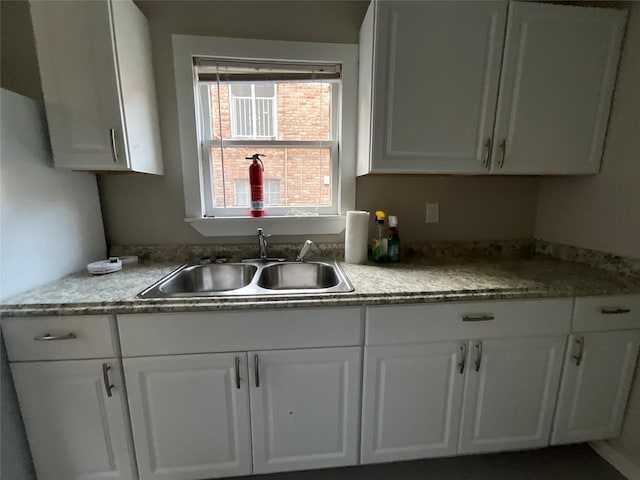 2518 Grant St, Houston, TX 77006 - kitchen featuring a sink, white cabinets, and light countertops