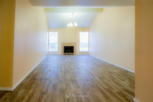 12500 Sandpiper Dr Unit 76, Houston, TX 77035 - unfurnished living room with a chandelier, wood finished floors, baseboards, and a fireplace