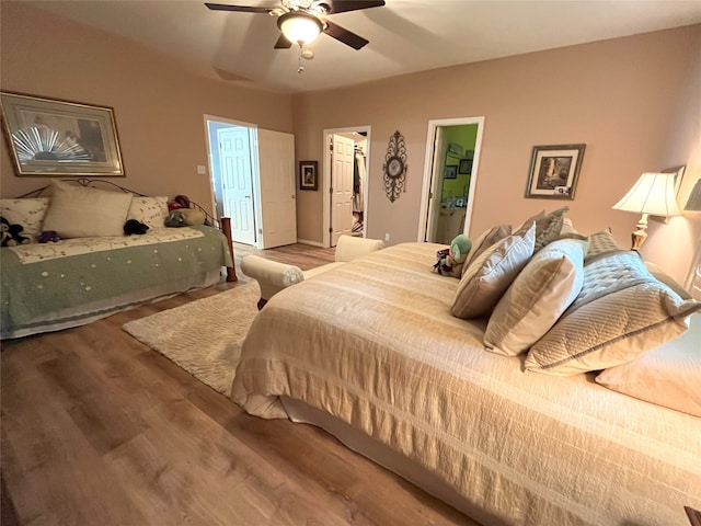 11683 Lakeshore Dr, Thornton, TX 76687 - bedroom featuring wood finished floors, a walk in closet, a closet, and ceiling fan