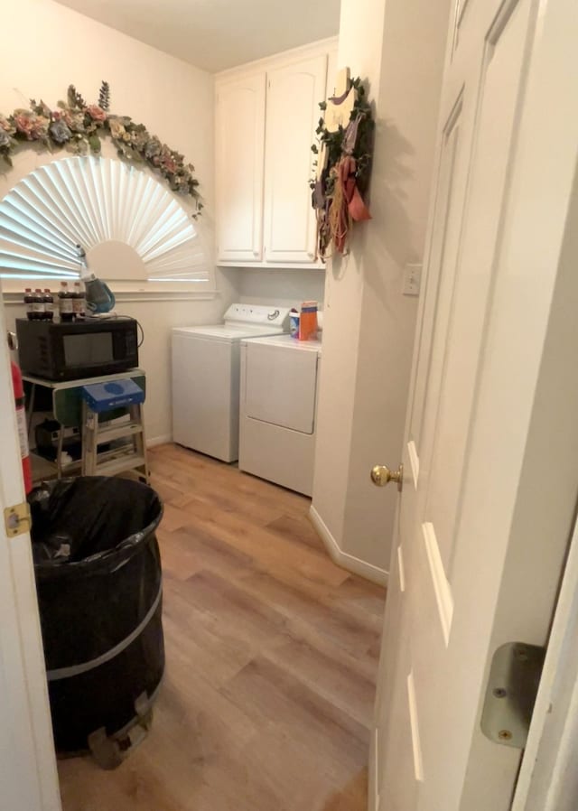 11683 Lakeshore Dr, Thornton, TX 76687 - washroom with light wood-type flooring, separate washer and dryer, cabinet space, and baseboards