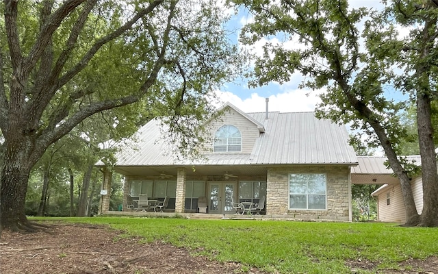 11683 Lakeshore Dr, Thornton, TX 76687 - back of property featuring stone siding, ceiling fan, french doors, a lawn, and metal roof