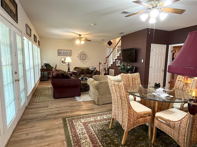 11683 Lakeshore Dr, Thornton, TX 76687 - dining room featuring a ceiling fan, stairway, healthy amount of natural light, and light wood-style floors
